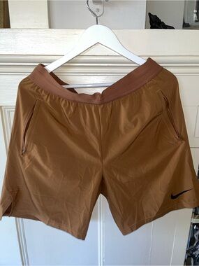 Nike Men's Tan Athletic Shorts.